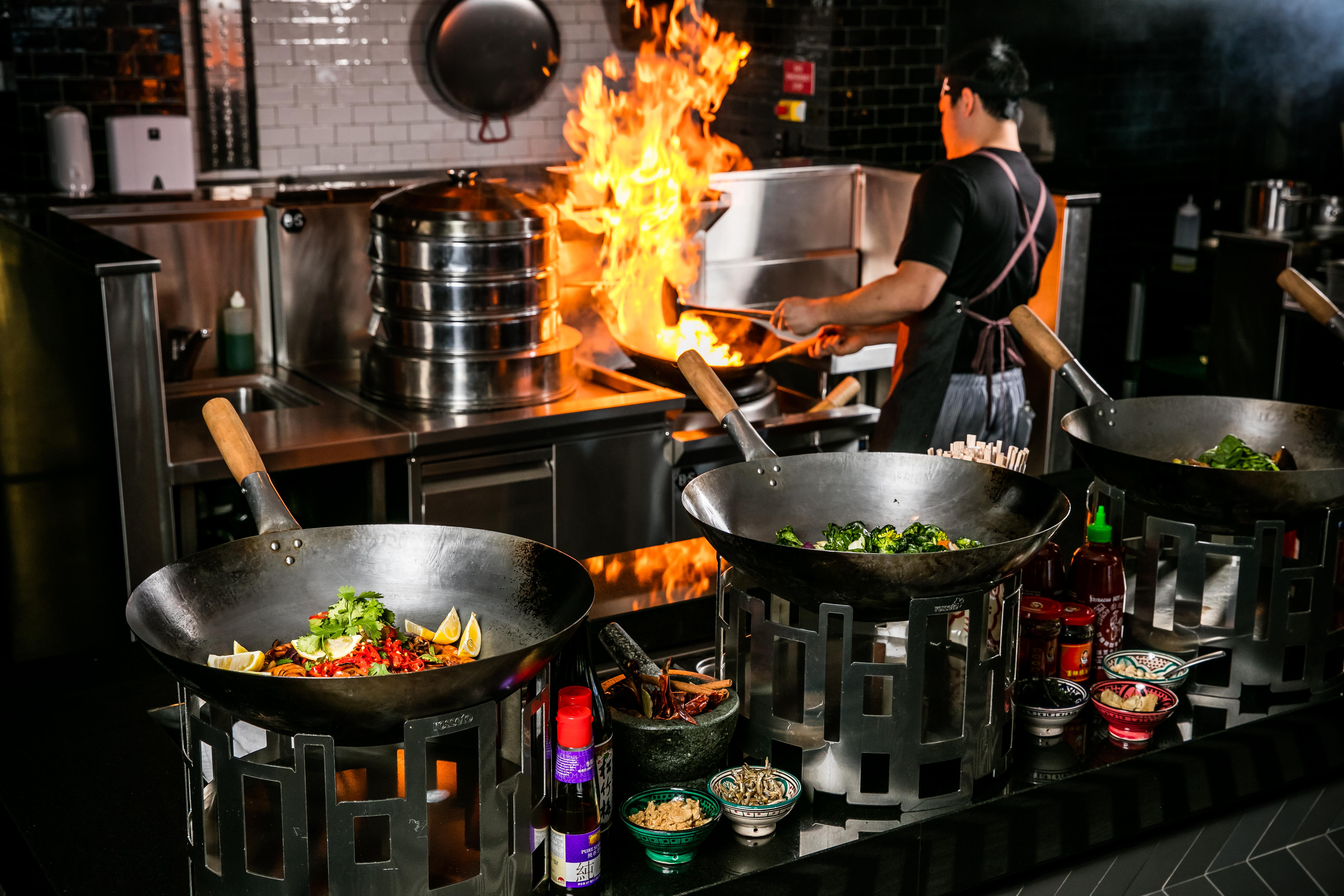 Qt Queenstown Exterior photo A wok being used in a restaurant kitchen